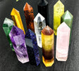 Collection of colorful crystal points on a dark textured background with AierCrystal branding.