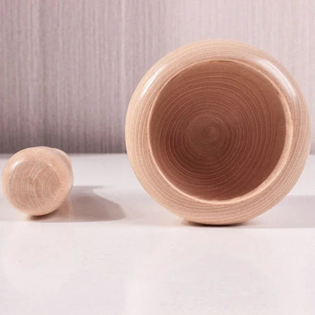 Wooden bowl and cylindrical block on a light background