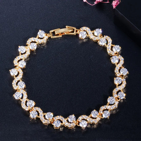 Gold bracelet with diamonds on a dark background