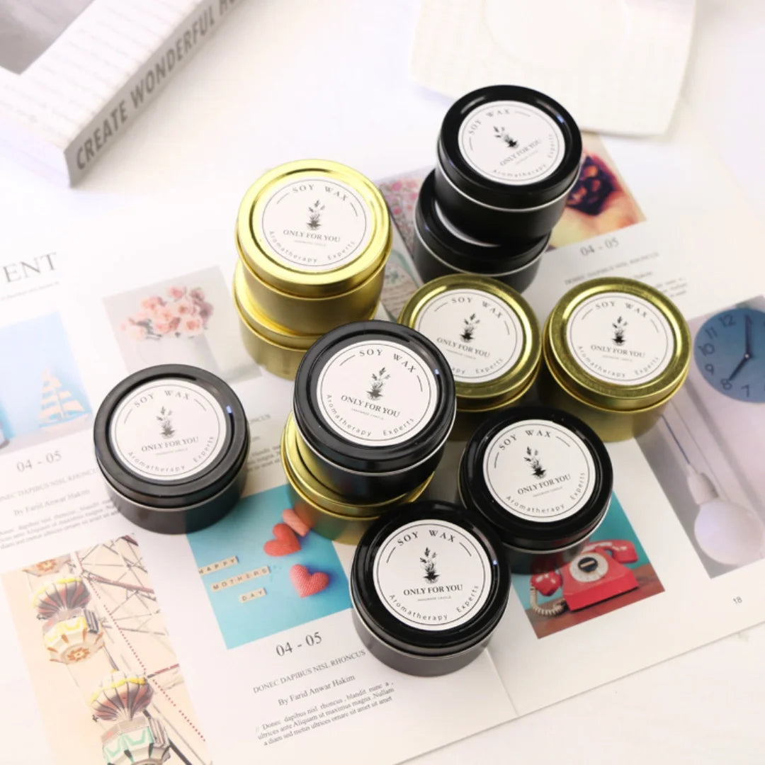 Collection of small candles in metal tins on a magazine background