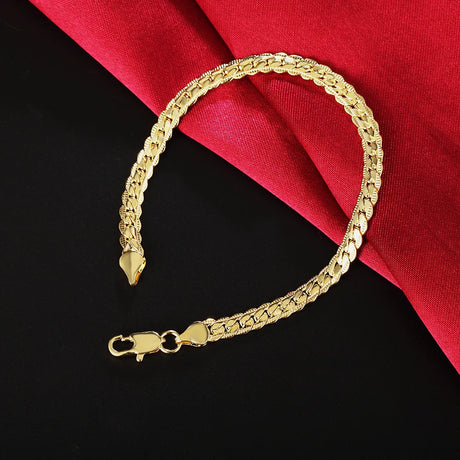 Gold bracelet on a black and red fabric background