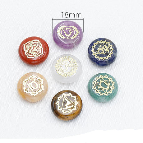Set of colorful crystal stones with engraved symbols on a white background