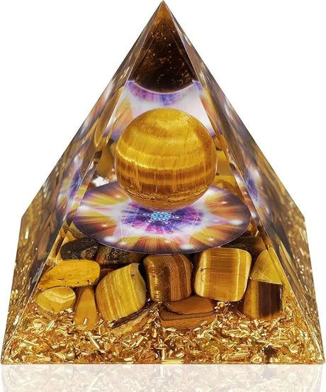 Crystal pyramid with gold balls and stones on a white background