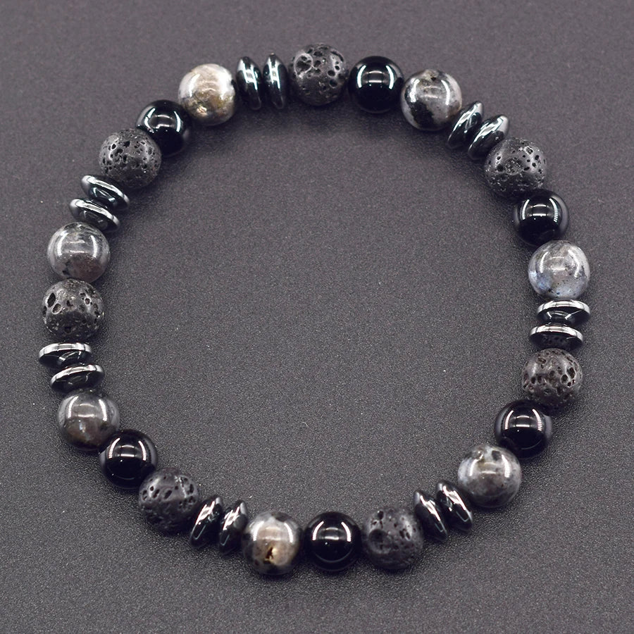 Bracelet with black and gray beads on a gray background