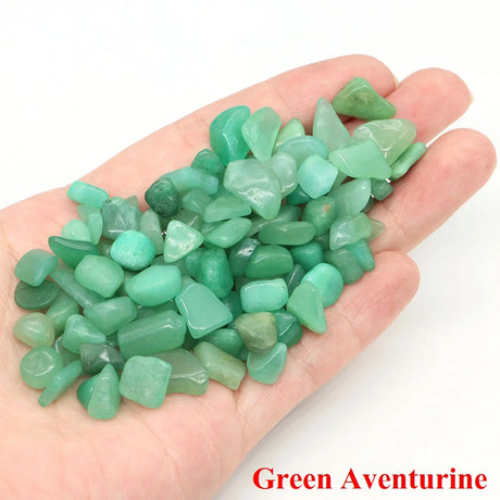 Hand holding green aventurine stones with 'Green Aventurine' text on a white background