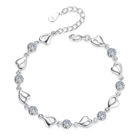 Silver bracelet with heart and crystal designs on a white background