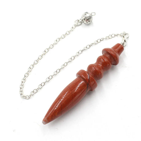 Red stone pendant on a silver chain against a white background