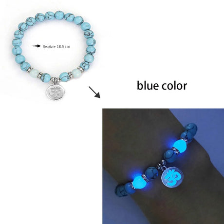 Blue beaded bracelet with a charm, shown on a wrist against a blue background.