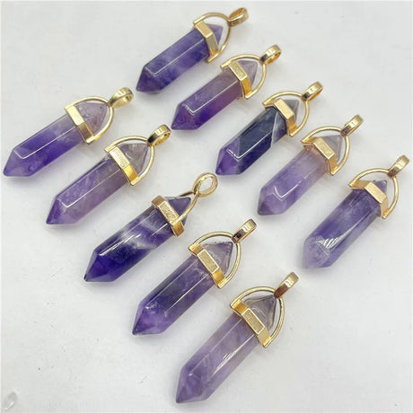 Purple crystal pendants with gold accents on a white background