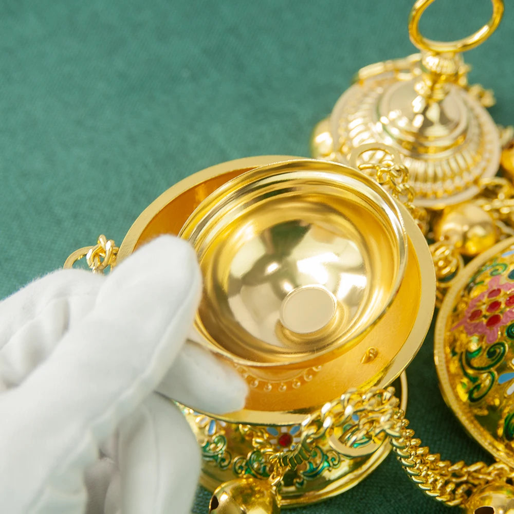 Gold jewelry with intricate designs on a green background