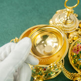 Gold jewelry with intricate designs on a green background