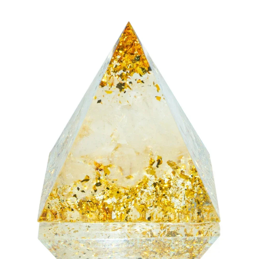 Triangular crystal with gold inclusions on a white background