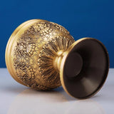 Decorative gold sphere with intricate patterns on a blue background