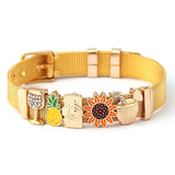 Gold bracelet with various charms on a white background