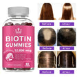 Bottle of biotin gummies with before and after hair health images on a white background