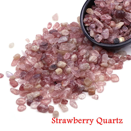 Strawberry Quartz stones with a black bowl on a white background