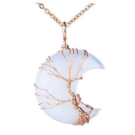 Crescent moon-shaped pendant with tree design and rose gold accents on a white background