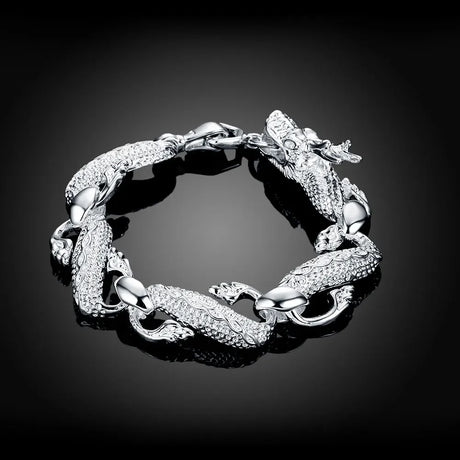 Silver bracelet with intricate design on a black background