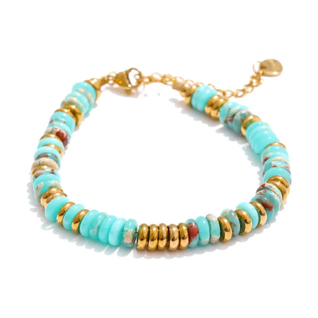 Bracelet with turquoise and gold beads on a white background