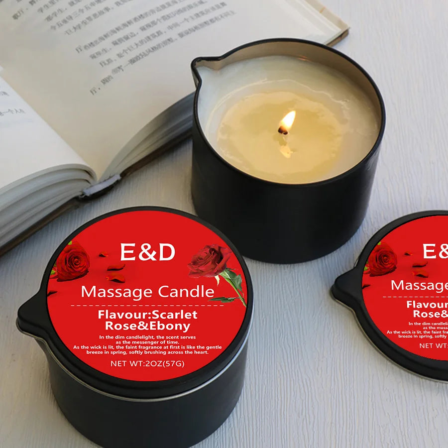 Massage candle with red label featuring 'E&D' brand on a white surface with an open book.