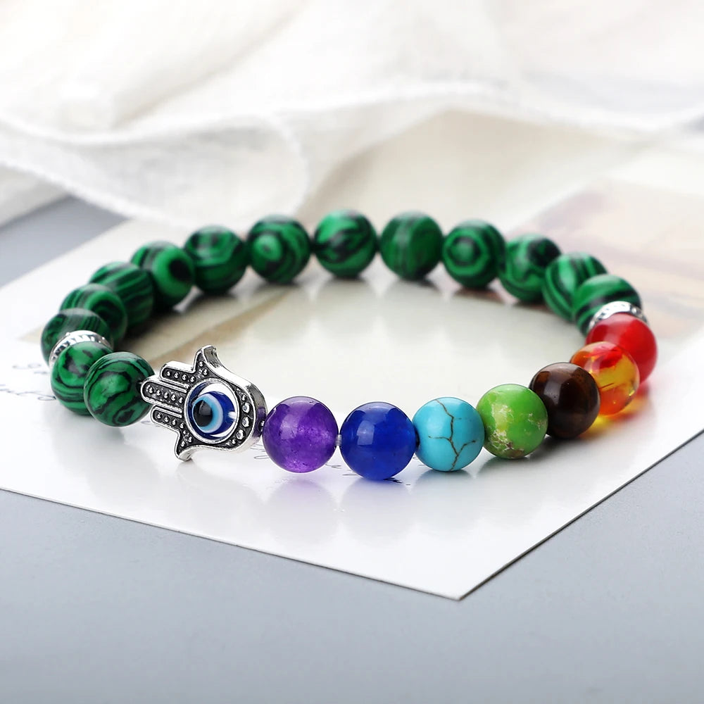 Colorful beaded bracelet with a Hamsa hand charm on a white background