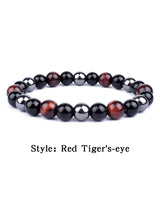 Beaded bracelet with red and black stones on a white background