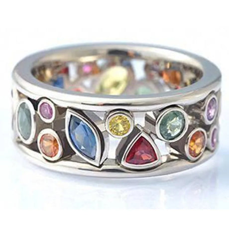 Silver ring with multicolored gemstones on a white background