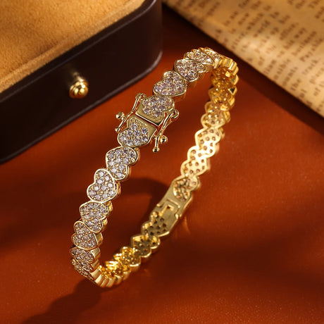 Gold bracelet with diamond accents on a brown surface
