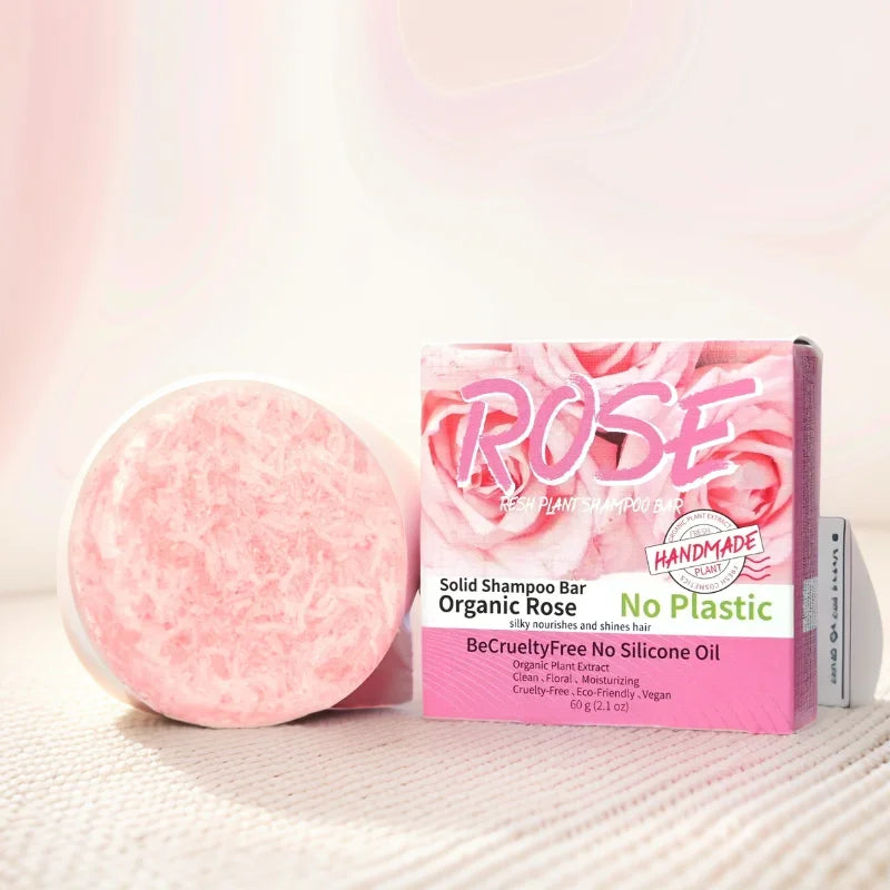 Pink solid shampoo bar with packaging labeled 'Rose' on a light background