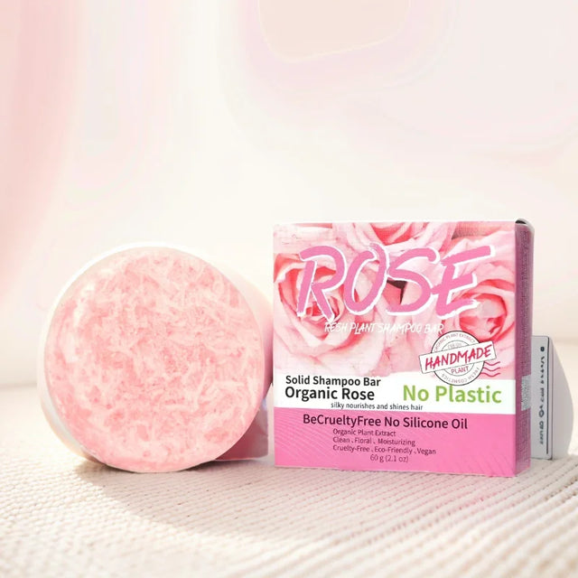Pink solid shampoo bar with packaging labeled 'Rose' on a light background