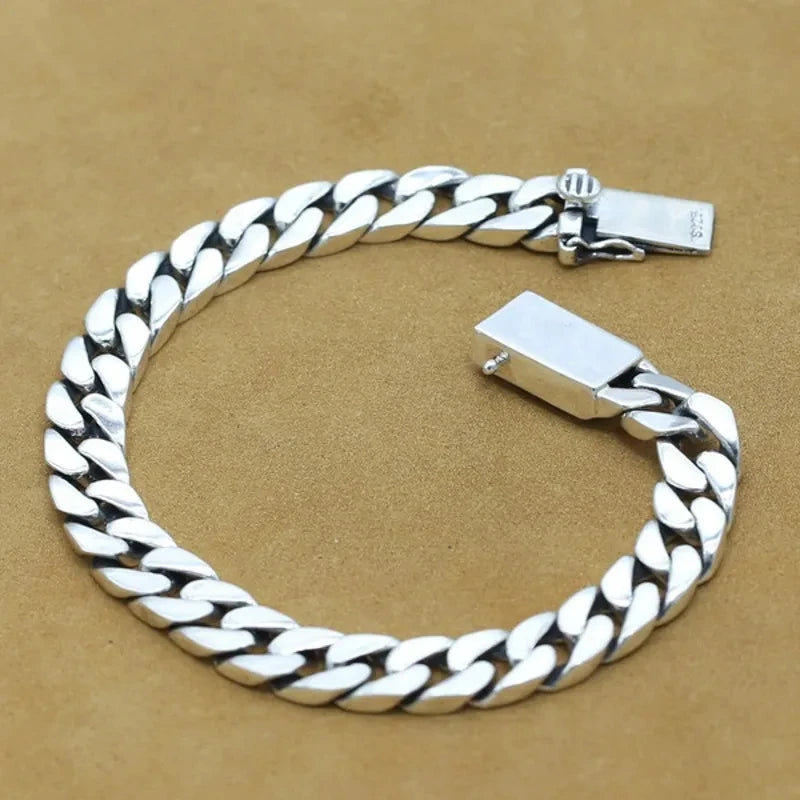 Silver chain bracelet on a beige background
