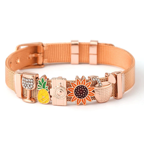 Rose gold dog collar with various charms on a white background