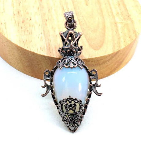 Decorative pendant with a light blue stone on a white background