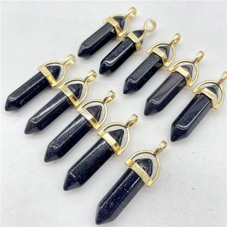 Set of black stone pendants with gold accents on a white background