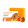 Persimmon goat milk soap bar with packaging on a white background