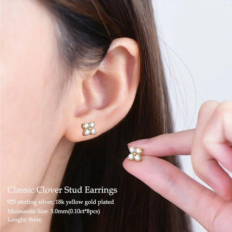 Close-up of a person wearing Classic Clover Stud Earrings with text detailing earring specifications.