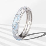Silver ring with floral design on a white background