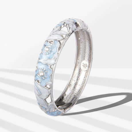Silver ring with floral design on a white background