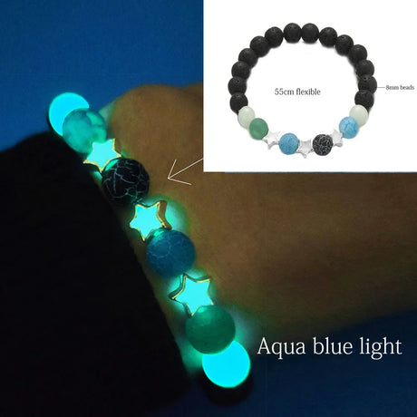 Glowing bracelet with black, green, and blue beads on a dark background