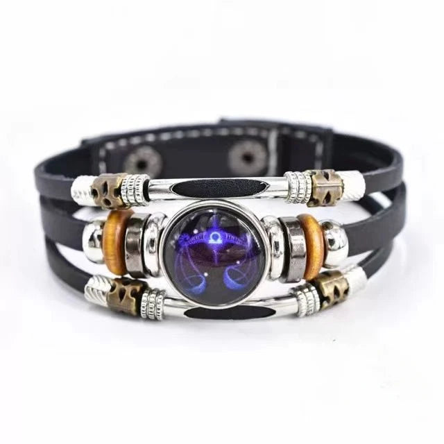 Multistrand bracelet with metallic and leather components on a white background