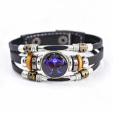 Multistrand bracelet with metallic and leather components on a white background