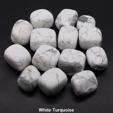 White turquoise stones on a black background