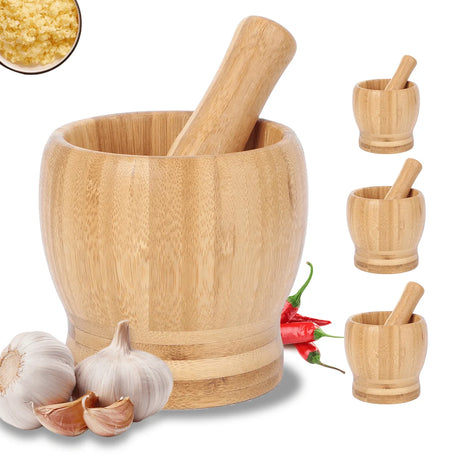 Wooden mortar and pestle with garlic and red peppers on a white background