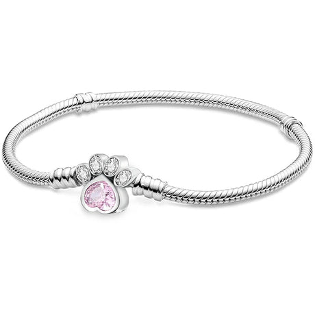 Silver bracelet with a paw-shaped charm featuring a pink gem on a white background