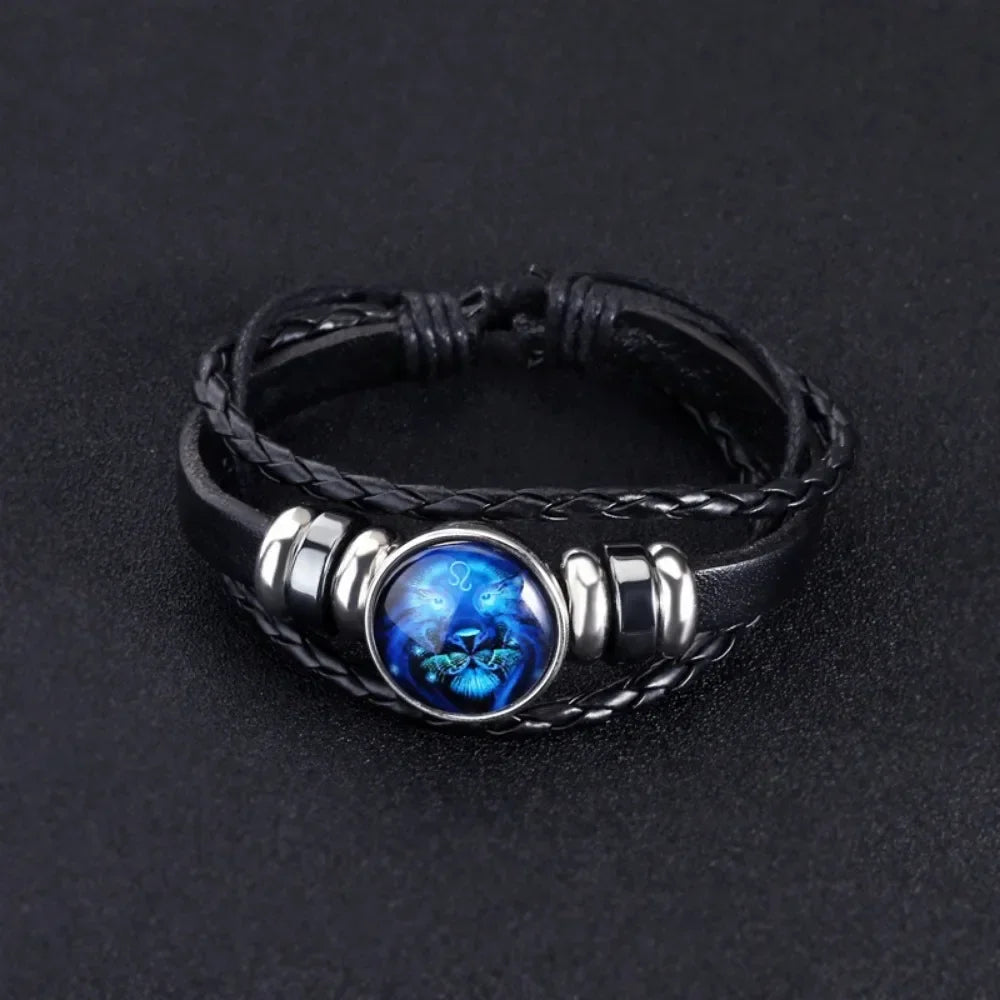 Black braided leather bracelet with a blue stone and silver accents on a dark background