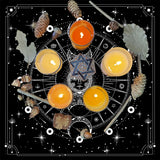 Wiccan or pagan altar setup with candles, crystals, and nature elements on a black background.
