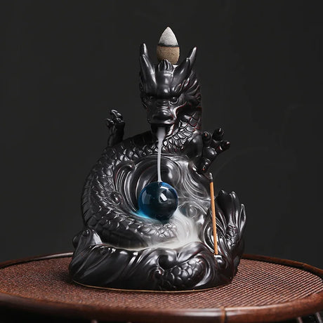 Dragon-shaped incense burner with incense on a dark background