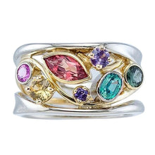 Ring with colorful gemstones on a white background