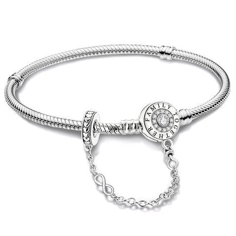 Silver bracelet with a circular clasp and chain extension on a white background