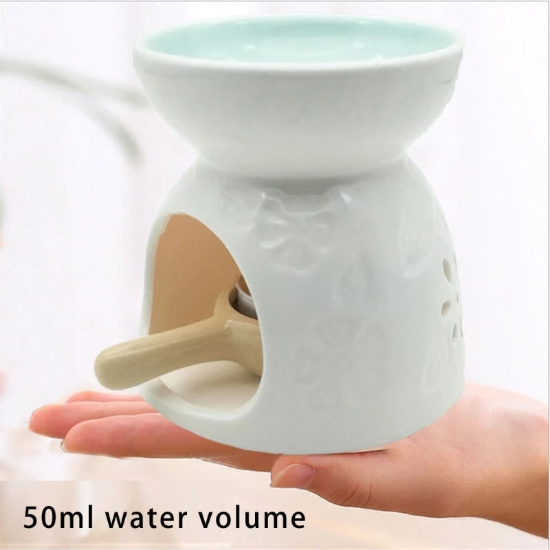 White ceramic oil burner held in a hand with '50ml water volume' text.